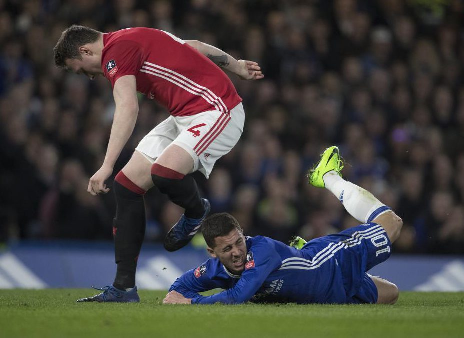  Chelsea playmaker Eden Hazard and Man Utd defender Phil Jones tussle in the quarter-final