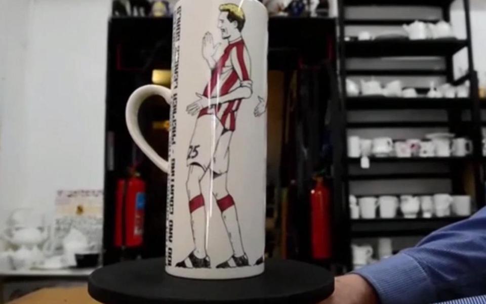  The special mug has images of robot celebrations by veteran frontman Crouch