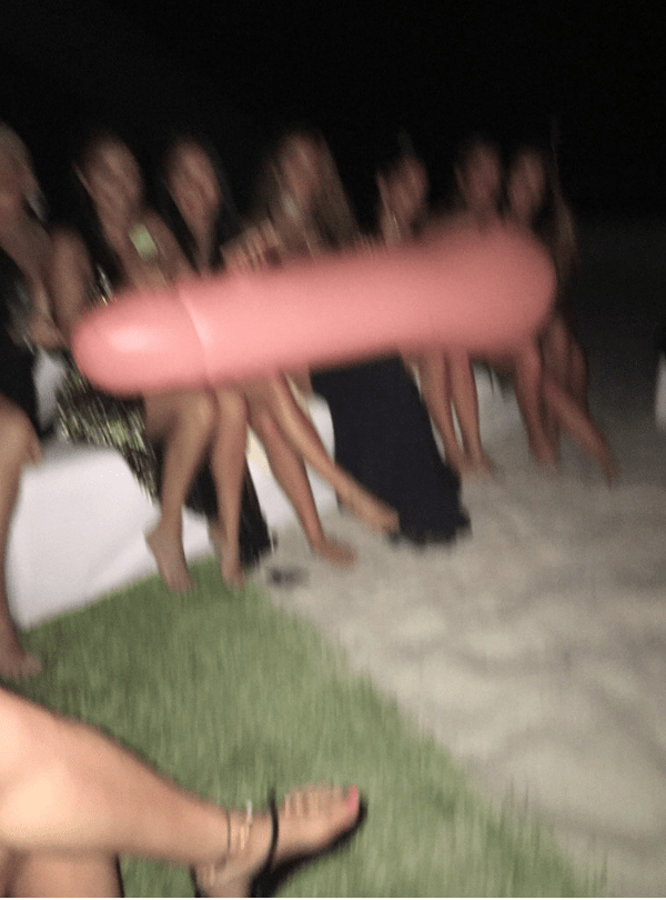 Kim shared a picture of the girls posing with a very rude inflatable