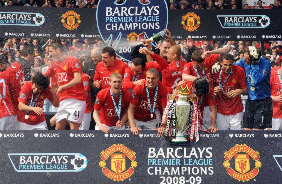 Manchester United players celebrate a third-consecutive Premier League title