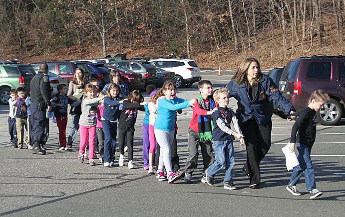  Surviving kids are rushed from Sandy Hook school following a killing spree in December 2012