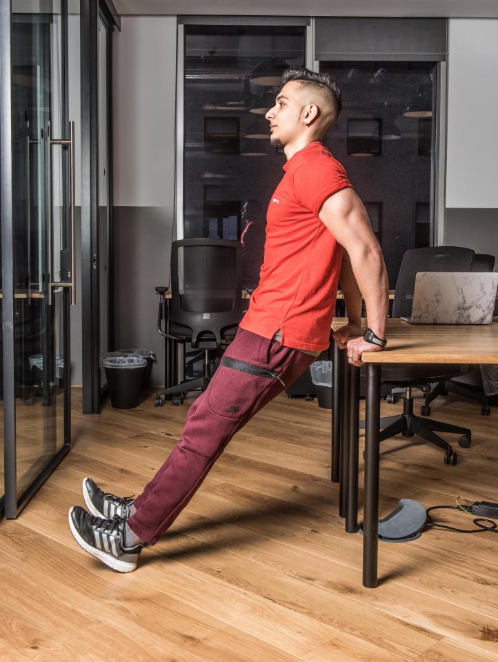  Turn your back to your desk and hold on to support yourself for this exercise