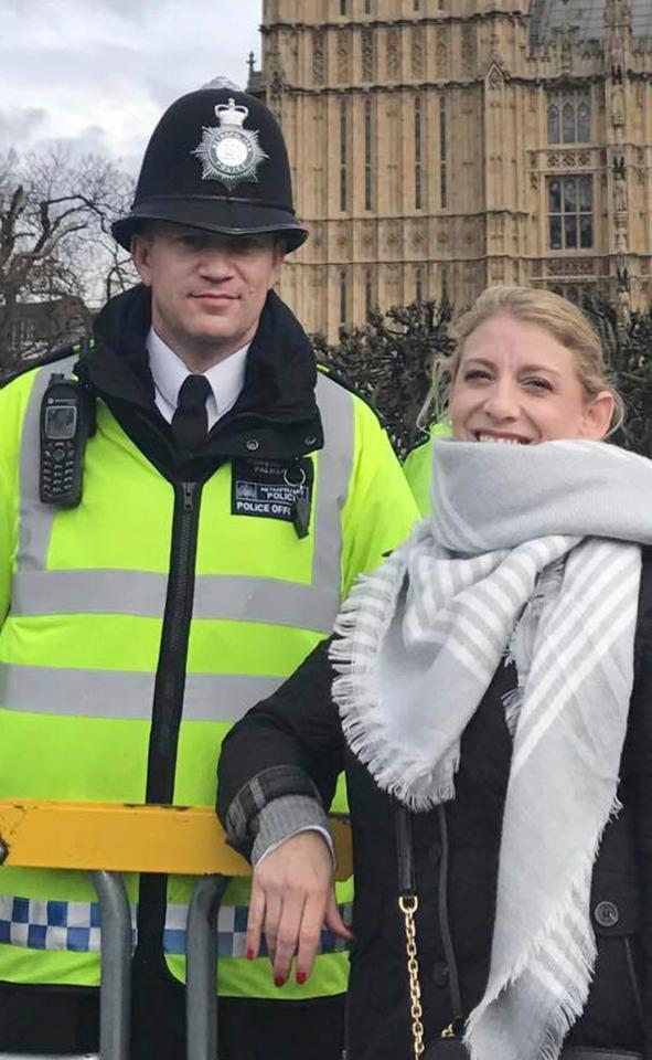 The hero cop posing with a tourist just hours ahead of the Westminster attack where he lost his life 