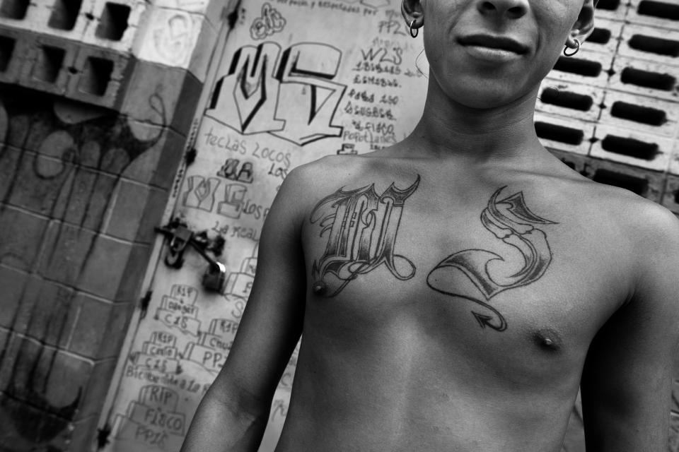  A young man shows off his gang tattoos in the prison of Tonacatepeque