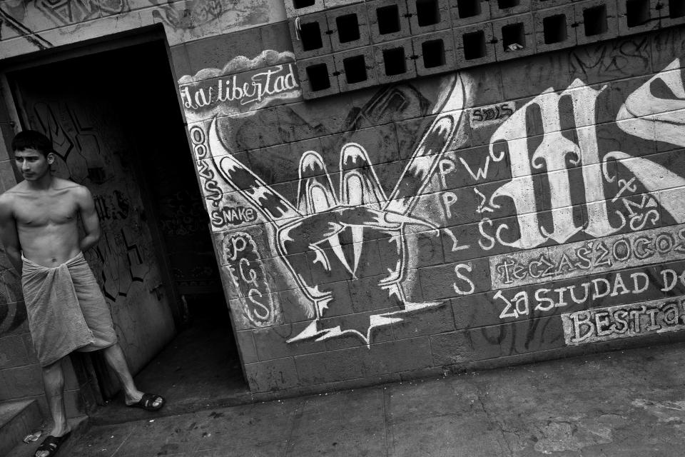  A member of the Mara Salvatrucha gang (MS-13) stands in front of his cell in the prison of Tonacatepeque