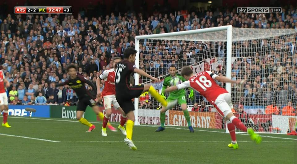 Nacho Monreal uses his arm to block Jesus Navas' shot 