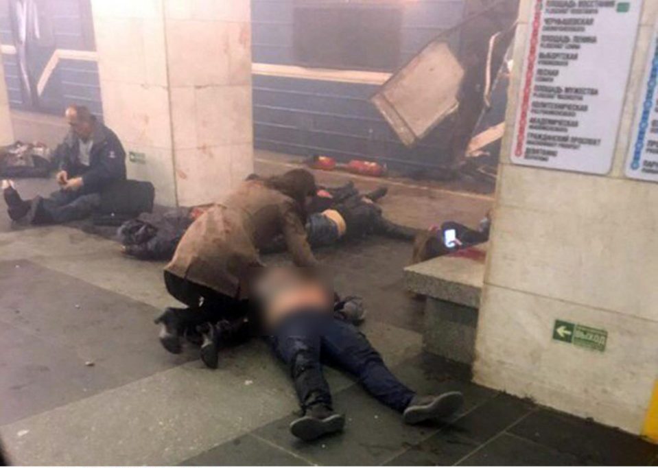  The bloodied bodies of injured passengers lie scattered on the ground yards from the train