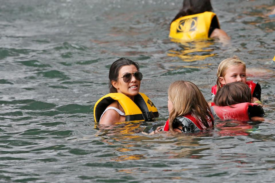  Kourtney took the older two children to enjoy the waterfall while Scott looked after Reign, two