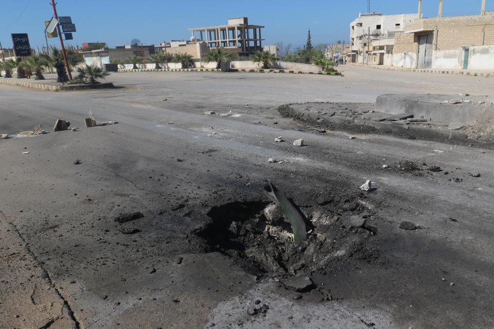 A shell crater is seen near the site of the alleged gas attack in Idlib province 