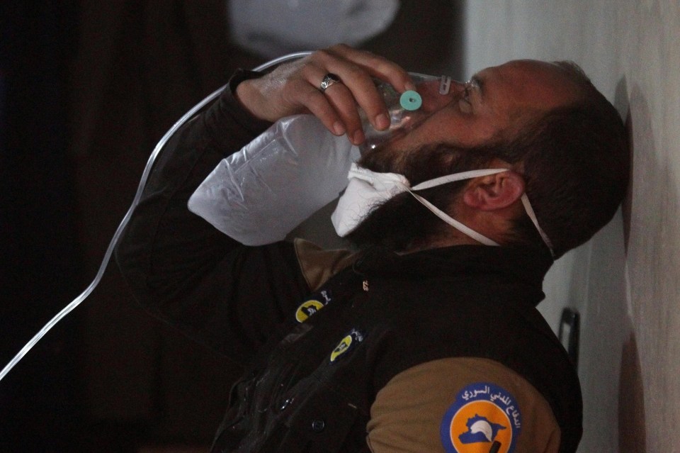 A volunteer rescuer receives oxygen after a suspected gas attack in Syria 