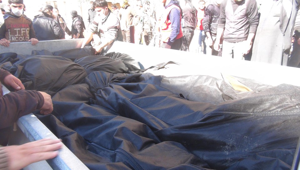 Bodies fill a truck after 58 people were reported to have been killed in the gas attack 