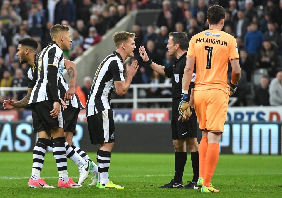 Newcastle players remonstrate with referee Keith Stroud over his decision