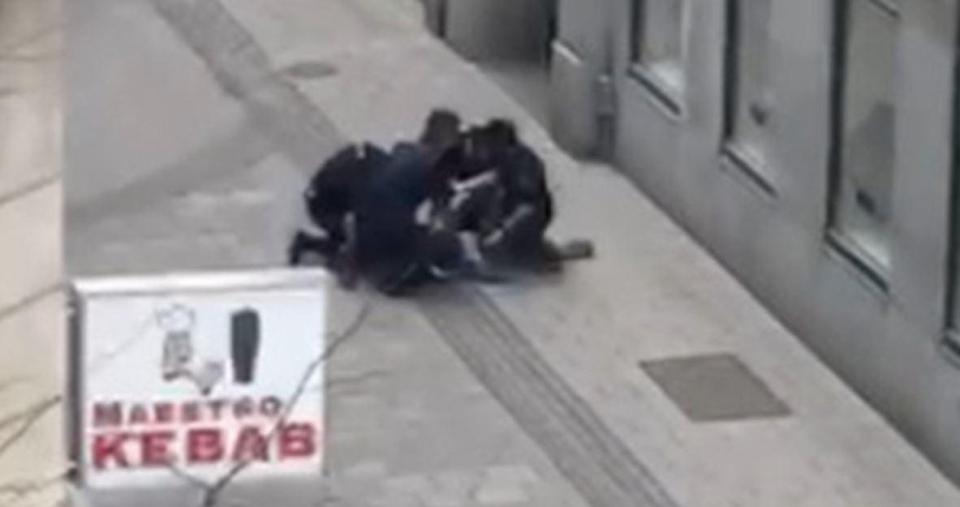 Officers can be seen holding a person down to the ground just after the truck crashed into a department store