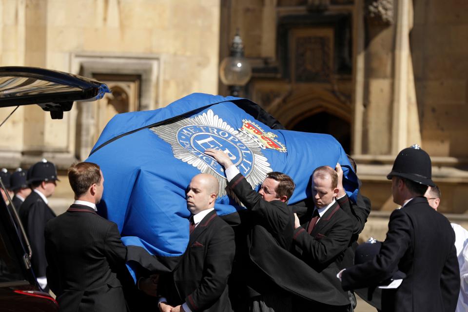 The coffin was draped in the Metropolitan Police's blue flag 