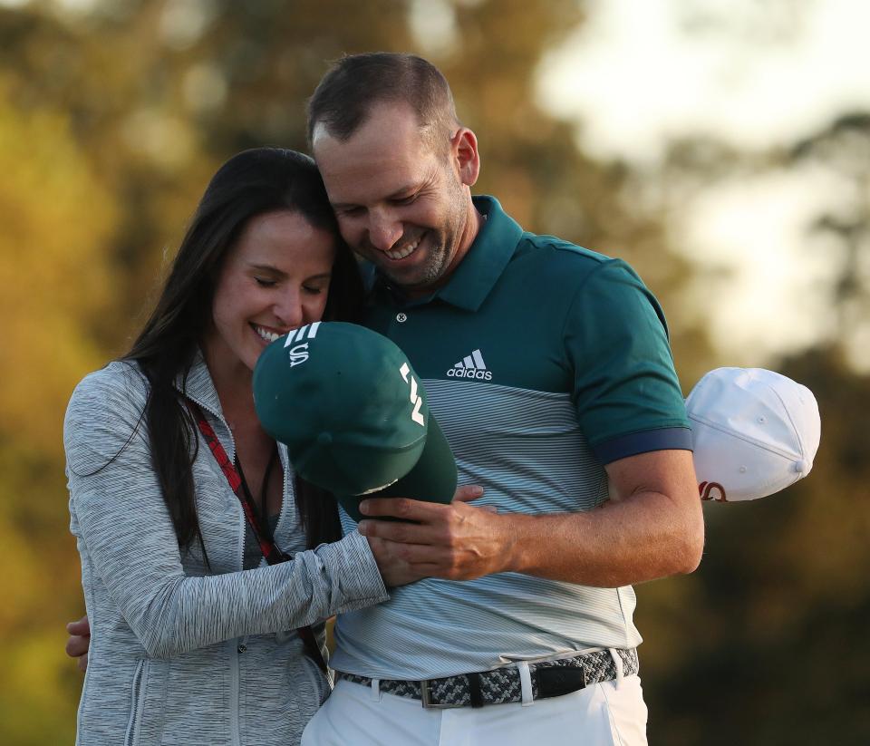  Sergio Garcia embraces fiancee Angela Akins after sinking the putt to win the Masters