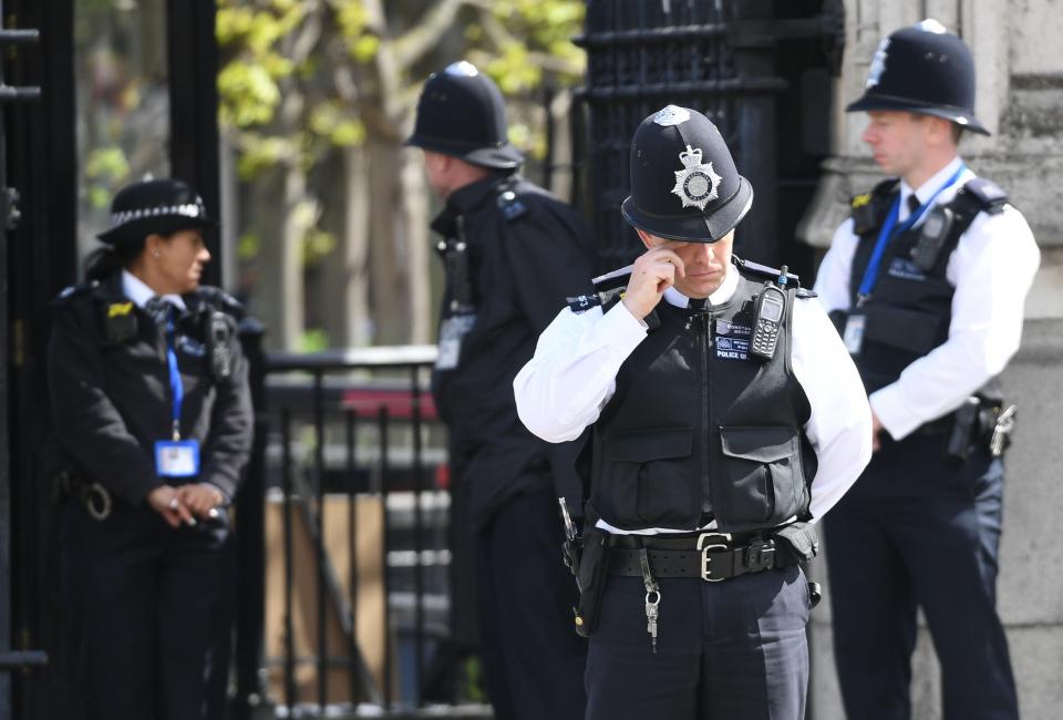 An officer rubs his eye ahead of the funeral of PC Palmer, who died in the Westminster terror attack