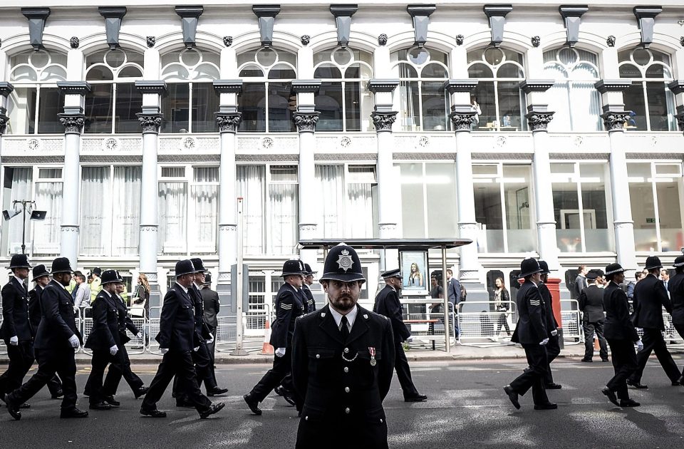 Police march into position on the route to Southwark Cathedral for the funeral of PC Palmer