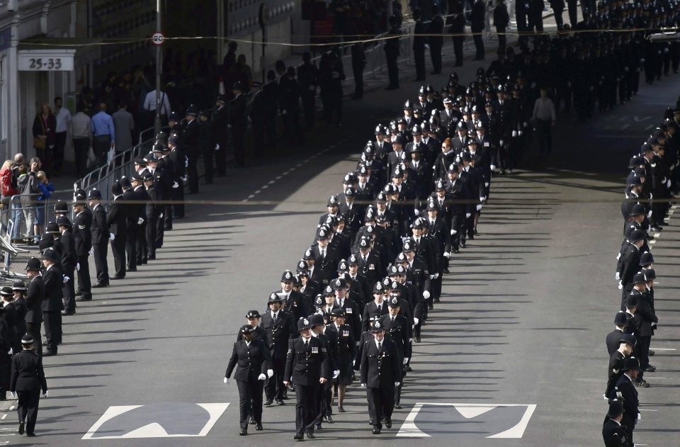 Cops march in an orderly fashion as a mark of respect for their late colleague 