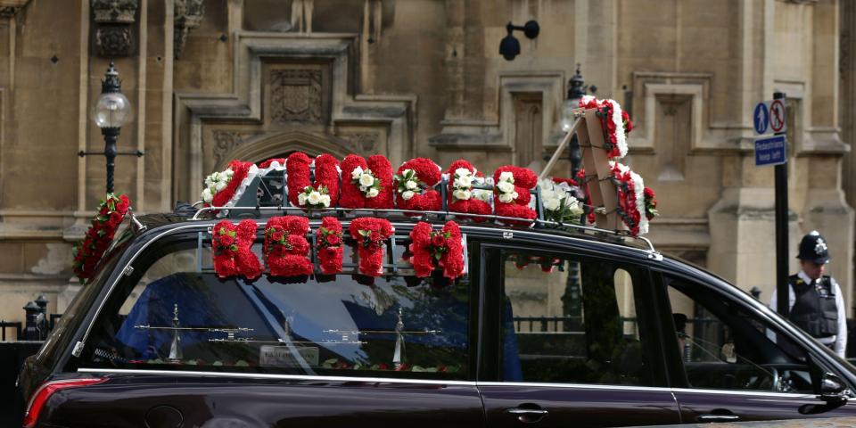 Another floral tribute on the hearse carrying the officer reads 'Uncle Keith'