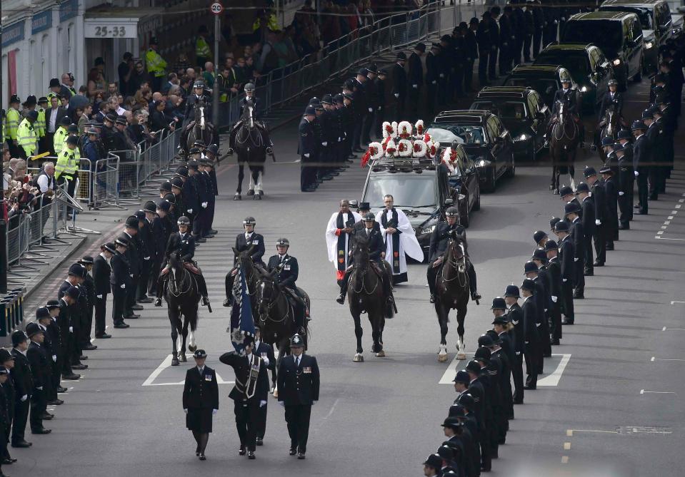 Thousands watched in silence as five jet black police horses lead the way to the service at Southwark Cathedral 