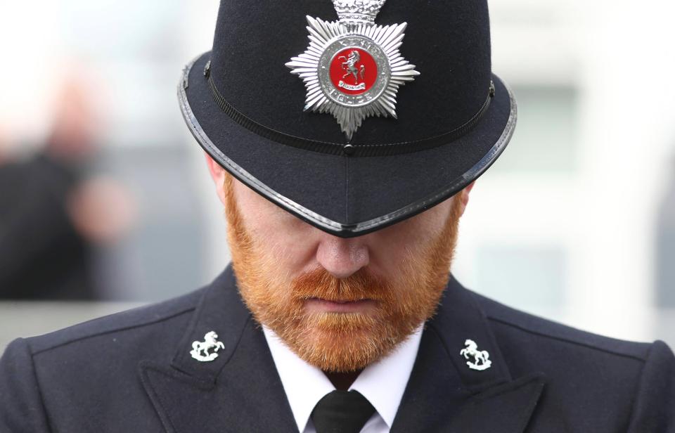 An officer bows his head as he listens to the service at Southwark Cathedral