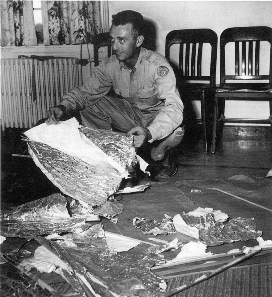 Major Jesse Marcel with debris found 75 miles north west of Roswell, NM, in June 1947 