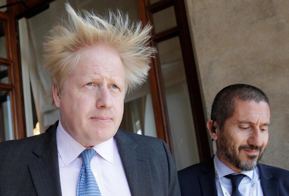  Hair-raising warning: Boris gets caught in a gust of wind during meetings in Italy