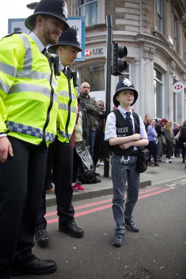 Nine-year-old Paul Warren stood next to police officers while paying his respects