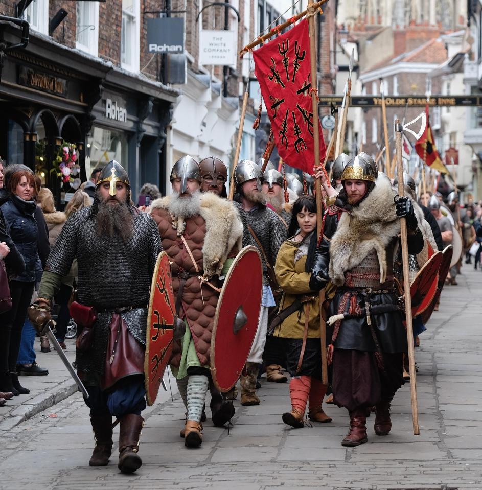 Vikings making their way through the streets of York as part of a reenactment parade 