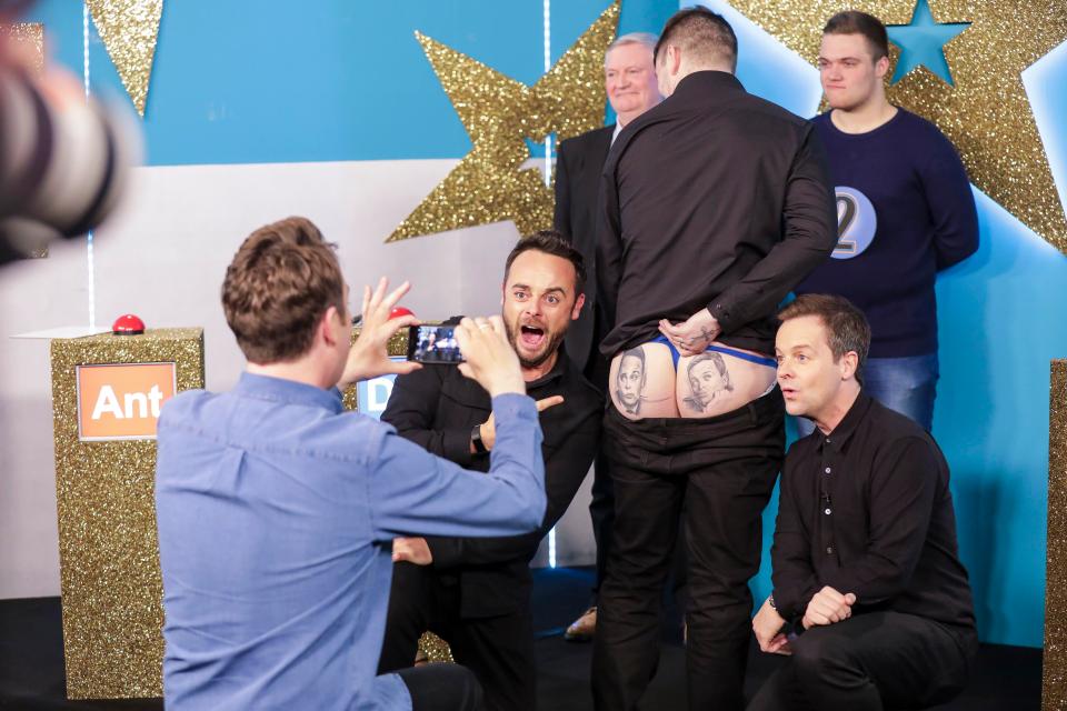  Ant and Dec pose with a man who has their faces tattooed on his bottom on Britain's Got More Talent