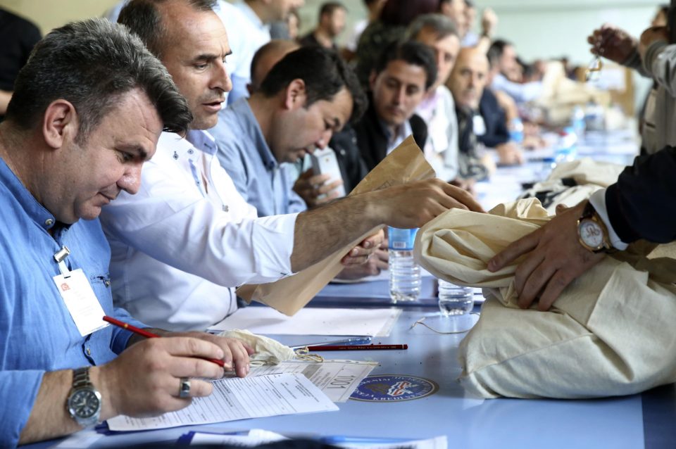 Electoral officials count votes earlier today in what was a close-run contest