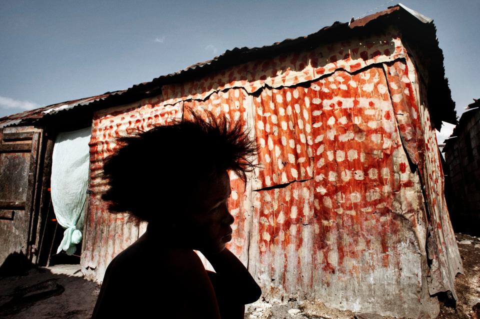  Claudine 27 years old sitting in front her shack