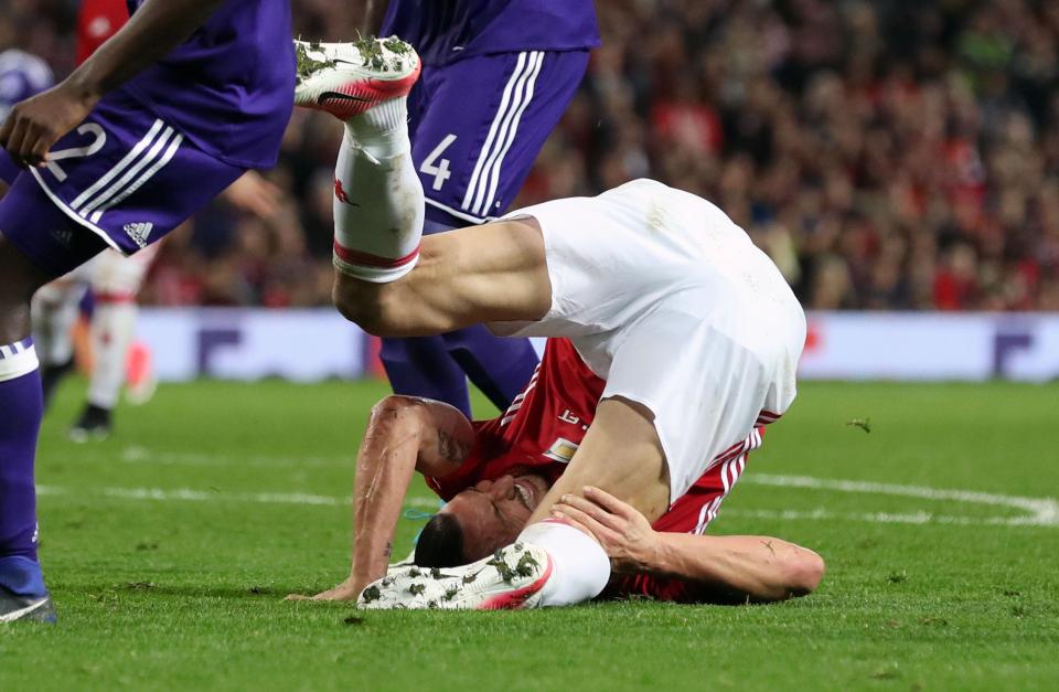 Zlatan Ibrahimovic takes a tumble after landing awkwardly on his knee and damaging ligaments in Manchester United's extra-time win over Anderlecht