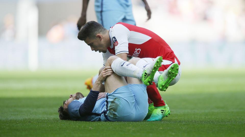  Gabriel apologises to David Silva after a heavy challenge on the Spaniard