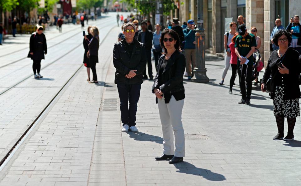  People stop and stand in silence on a Jerusalem street