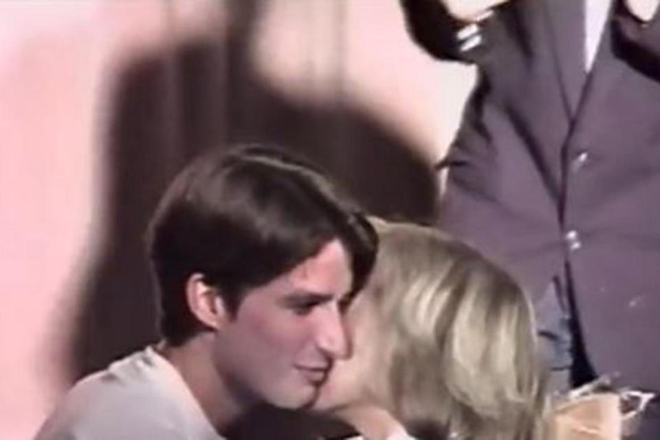 A 15-year-old Macron kisses his future wife on the cheek