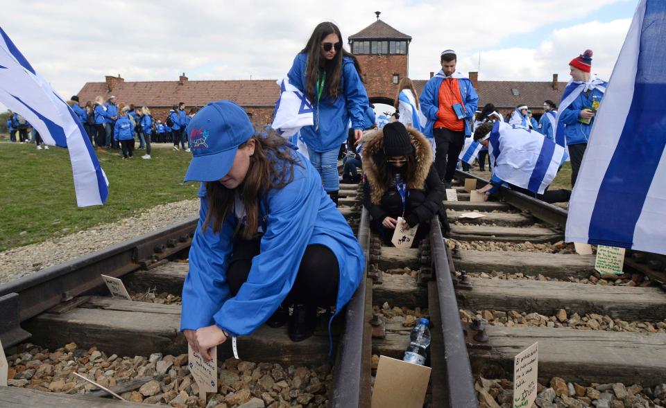  Participants of the yearly March of the Living place memory plaques on the rails in the former German Nazi Death Camp Auschwitz-Birkenau