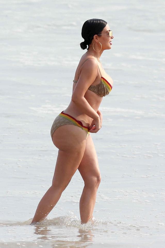  Kim appeared focused on the shoreline as she waded through the shallow water