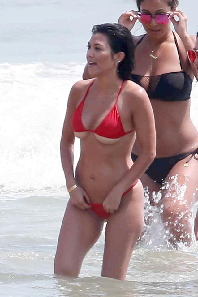  Kim's sister Kourtney was with her - wearing an eye-grabbing red bikini