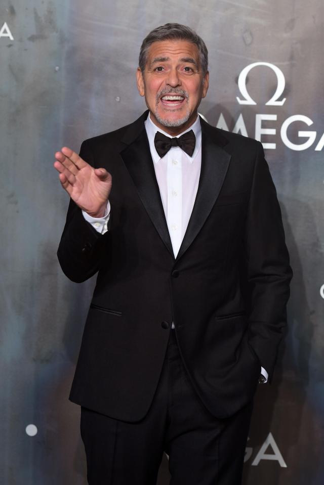  George Clooney made an animated entrance as he arrived at the event