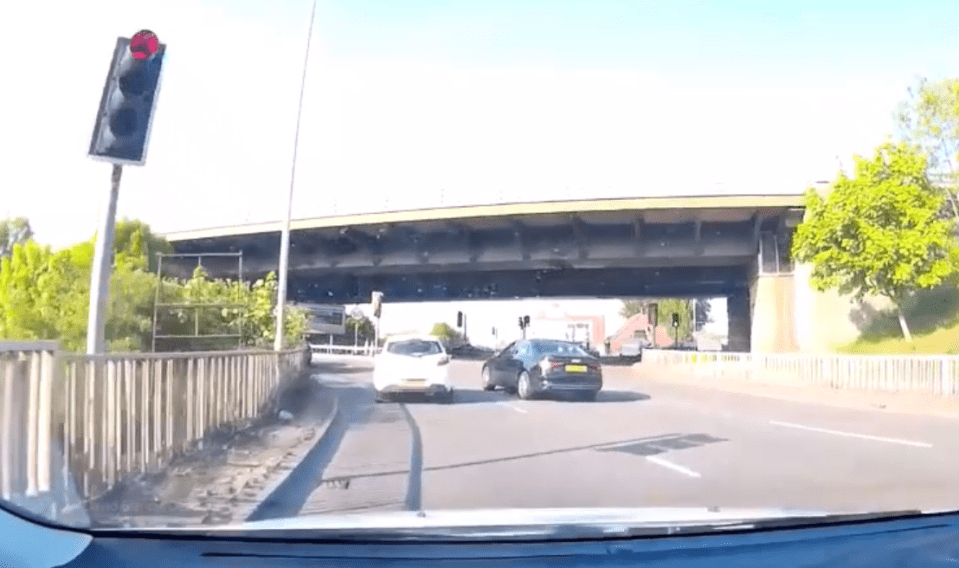  The moment two cars barge into each other on a confusing roundabout has been captured on dashcam