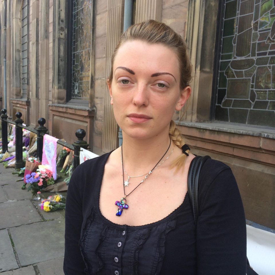 Music student Hannah Whittaker, 27, laid flowers at Manchester's St Anne's Church today