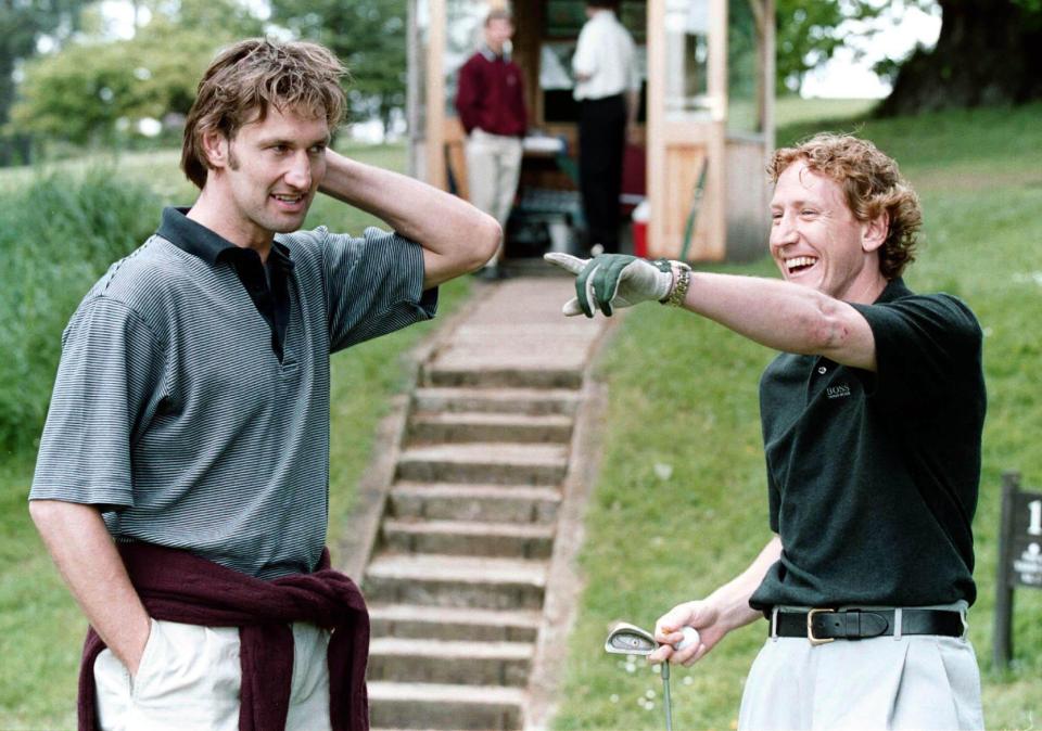  Adams and Parlour during a round of golf in 2000