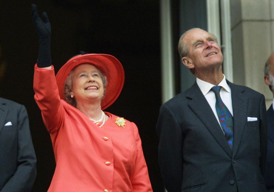  The Queen and Prince Philip watching a Concorde fly over Buckingham Palace