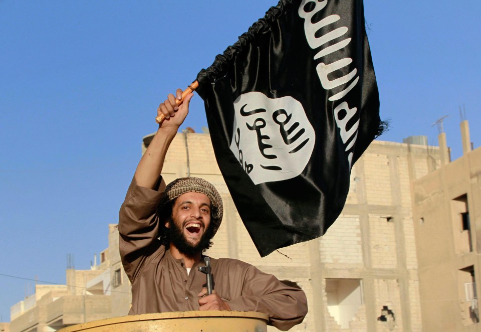 IS terrorist waves their black flag