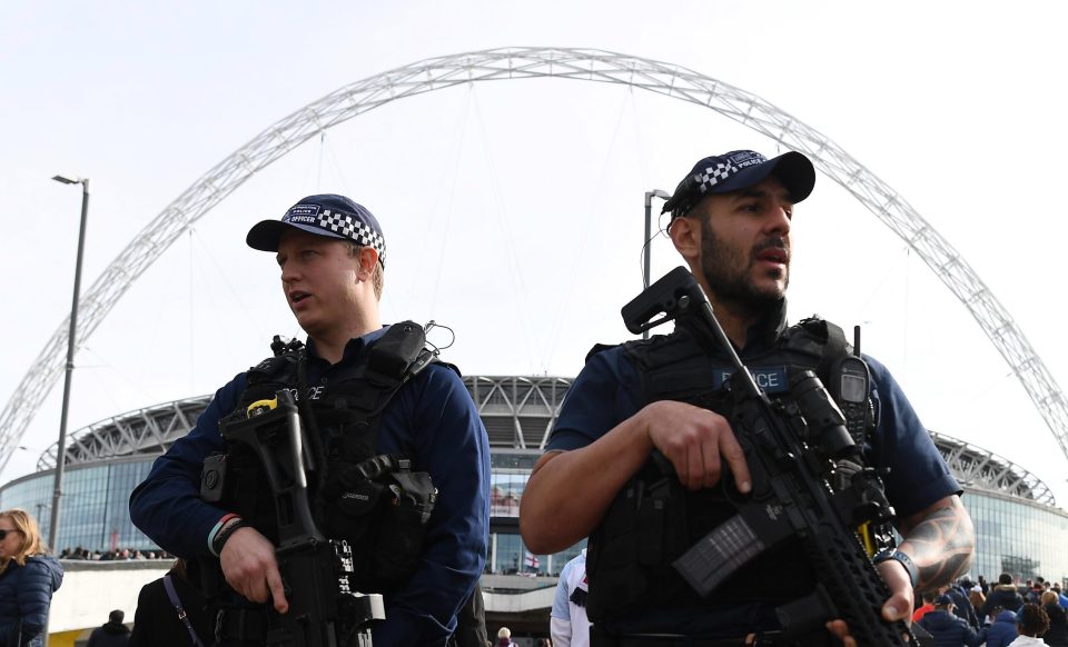  Armed police pictured outside Wembley stadium prior to the FIFA 2018 World Cup Qualifier in March - armed cops will make a return to the stadium this weekend