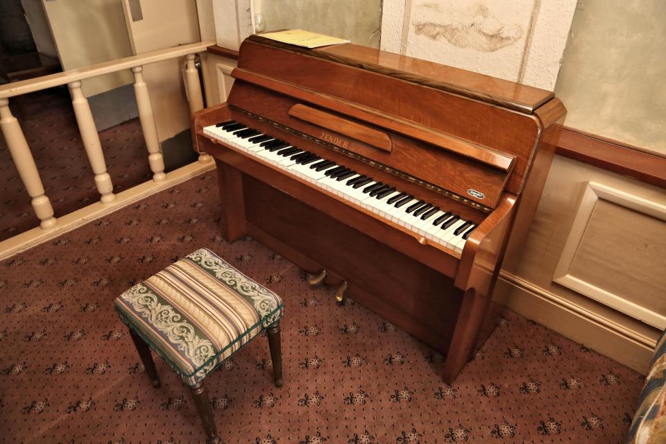  A piano that once would have been enjoyed by visitors stands silent