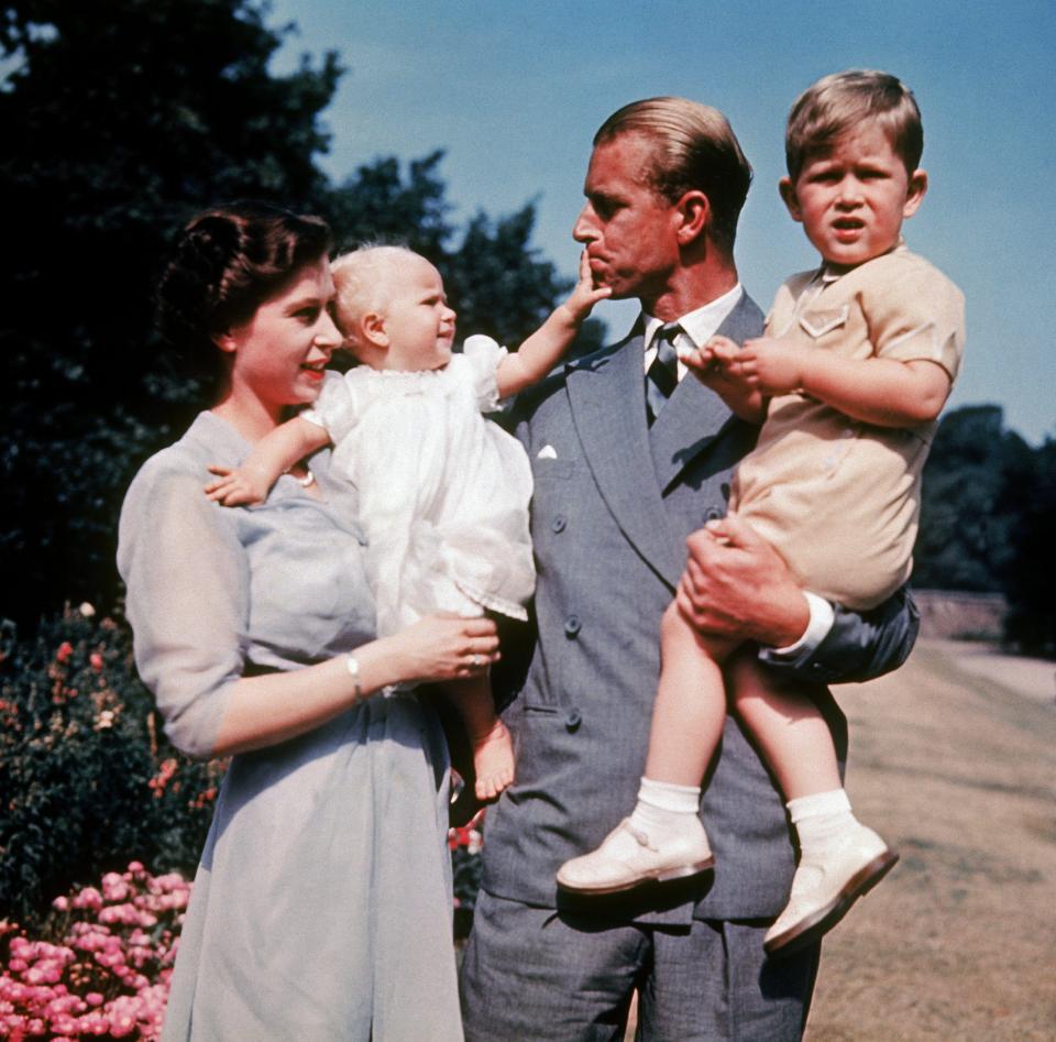  The first colour photograph of Princess Anne in 1951, in the arms of her mother the Queen with Prince Philip and a young Prince Charles