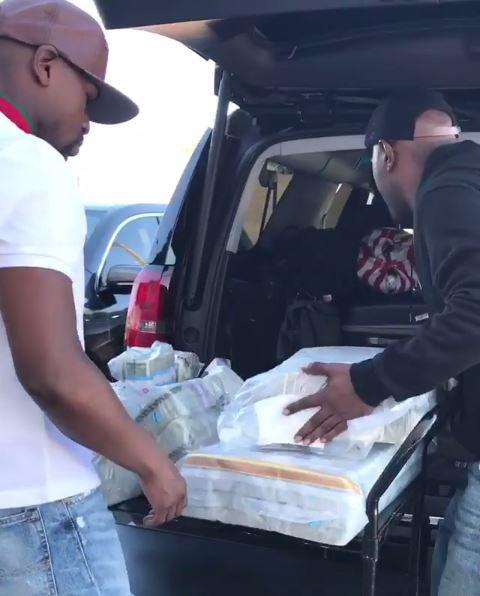 Floyd Mayweather oversees the exchange which sees bags full of his cash moved into his car