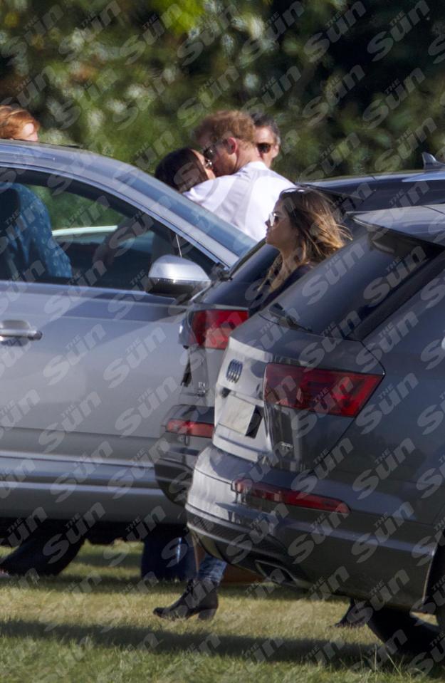  Couple are snapped having a sly snog before the charity polo match